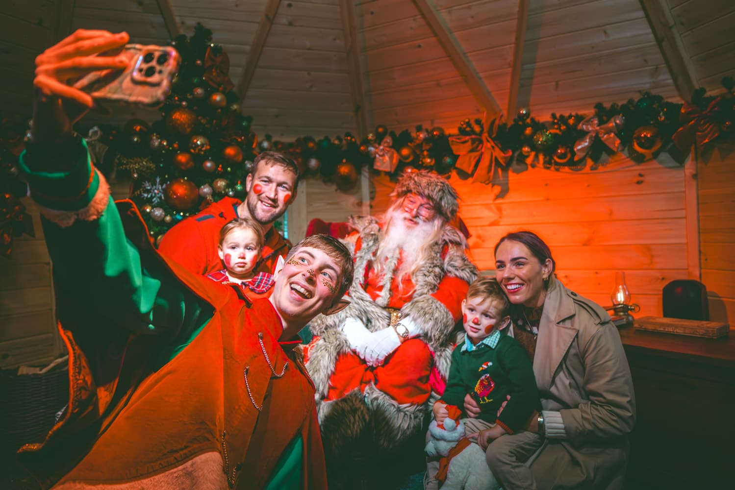Family and elf selfie in Santa's Lodge at Bluestone