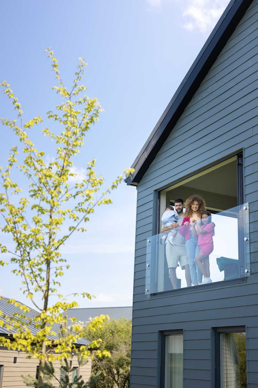 Close up of family looking out of Carningli Lodge sunroom