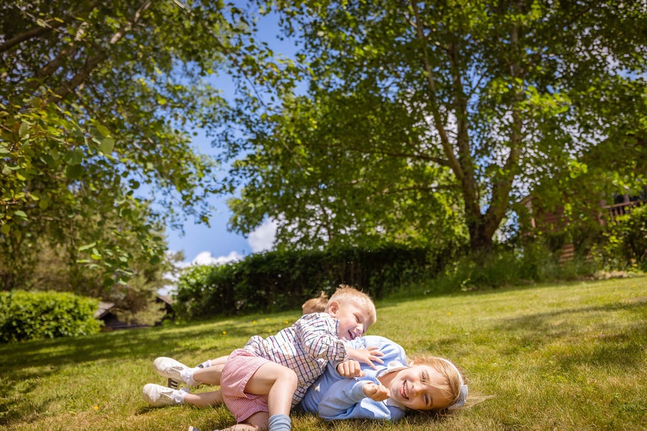 Children Playing On The Grass In The Sun
