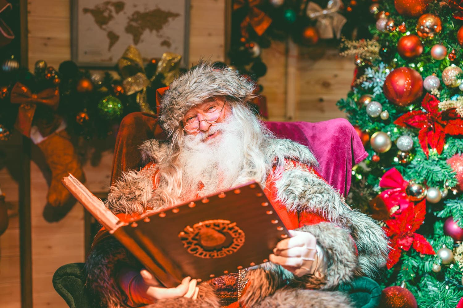Santa with book in Santa's Lodge at Bluestone