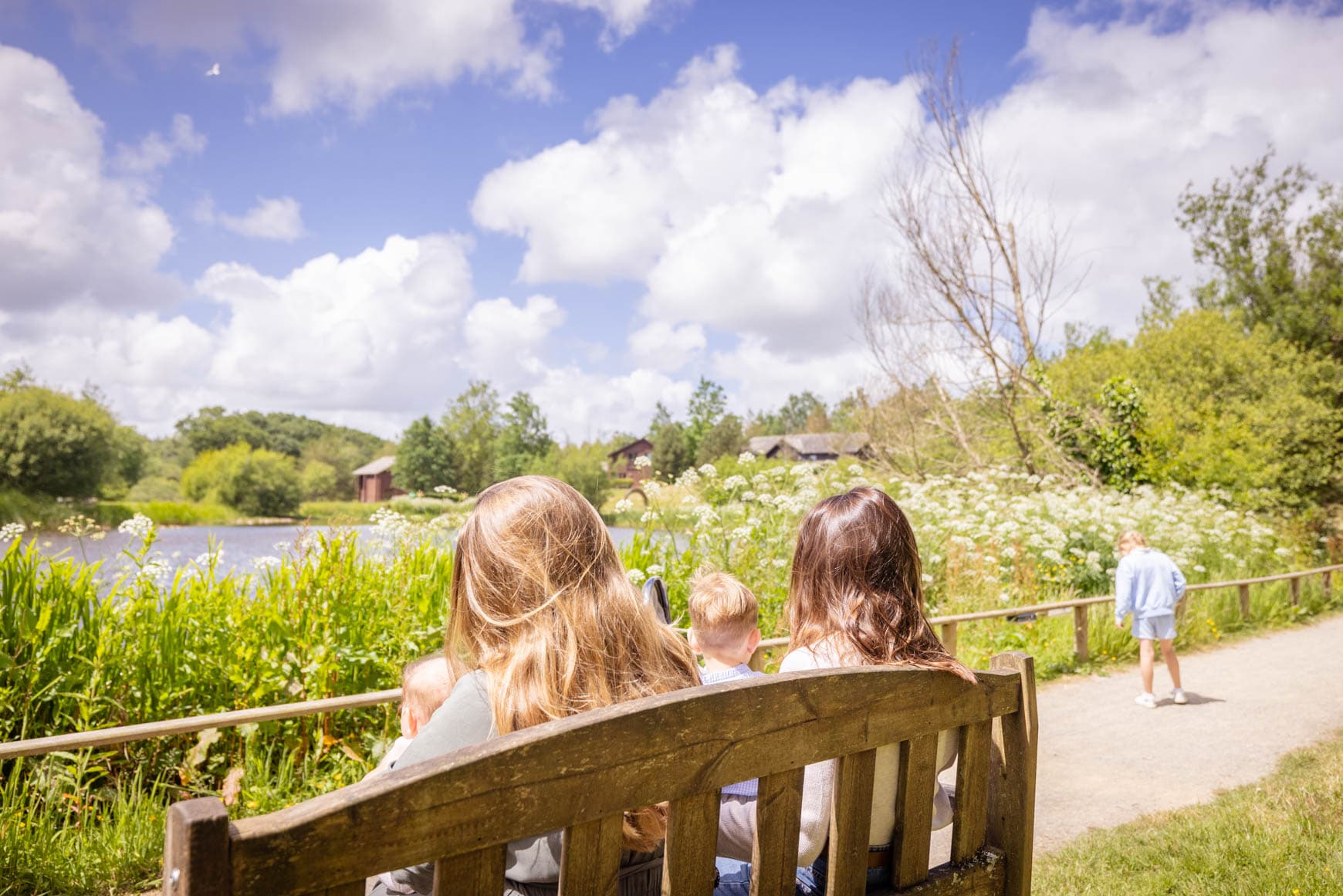 Children Sat On Bench By Bluestone Lake